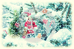 Fir tree covered snow, bunny Santa doll, candy cane, cookies, closeup. Winter Christmas greeting card manipulation background