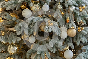 Fir tree decorated with christmas balls. Close-up view of beautiful christmas tree with colorful baubles and illuminated