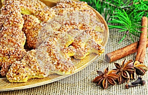 Fir tree shaped cookies for Christmas on plate. Shortcrust biscuits with cinnamon and sugar.