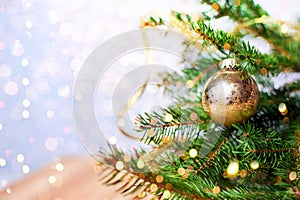 Fir-tree spruce with Christmas golden decor balls. Holiday background.