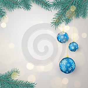 Fir twigs and blue Christmas balls with snowflakes ornament with space for greeting text. Christmas decoration elements.