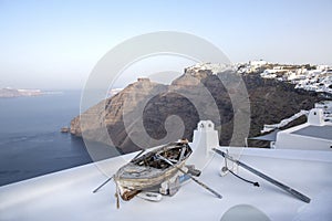 Fira panoramic view. Thira panoramic sea view. Greece Santorini island in Cyclades. Old boat on a terrace with view over Caldera,