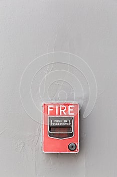 The fire alarm box is installed on exterior cement wall of residential building, safety concept.