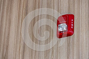 A fire alarm with built in strobe light to alert in case of fire. A sound and strobe fire alarm is mounted to an interior wall as