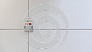 A fire alarm with built in strobe light to alert in case of fire. A sound and strobe fire alarm is mounted to an interior wall as