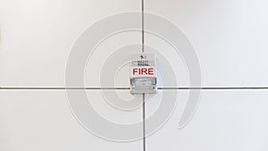 A fire alarm with built in strobe light to alert in case of fire. A sound and strobe fire alarm is mounted to an interior wall as