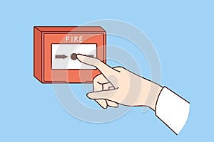 Fire alarm button on wall and hand of person who wants to notify everyone about emergency situation