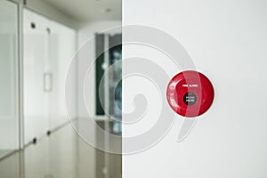 Fire alarm, emergency button on white wall in modern office