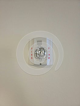 Fire alarm with strobe light on wall