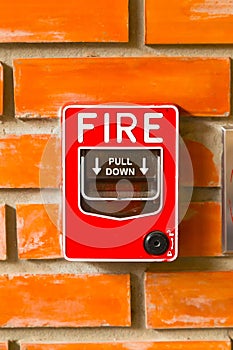 Fire Alarm Switch on the brick wall background texture.