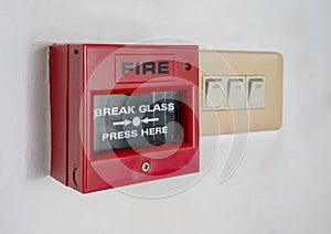 Fire alarm switch inside red plastic box