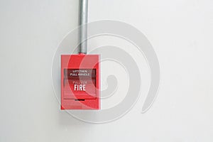 Fire alarm switch on white cement wall