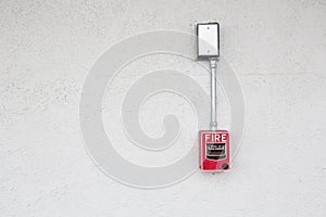 fire alarm switch at white wall