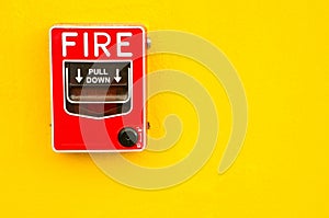 Fire alarm switch on yellow wall