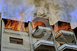 Fire in an attic of a building in an Italian city. Apartment on fire and flames