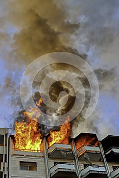 Fire in an attic of a building in an Italian city. Apartment on fire and flames