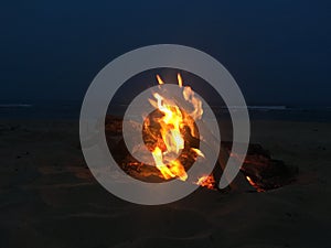 Fire on Beach during Full Moon Rising on Kauai Island, Hawaii.