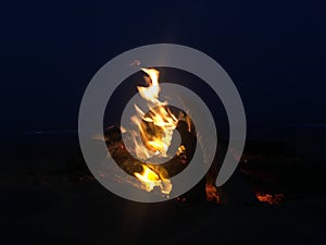 Fire on Beach during Full Moon Rising on Kauai Island, Hawaii.