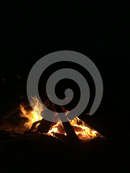 Fire on Beach during Full Moon Rising on Kauai Island, Hawaii.