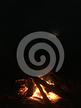 Fire on Beach during Full Moon Rising on Kauai Island, Hawaii.