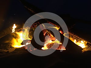 Fire on Beach during Full Moon Rising on Kauai Island, Hawaii.