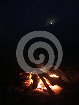 Fire on Beach during Full Moon Rising on Kauai Island, Hawaii.