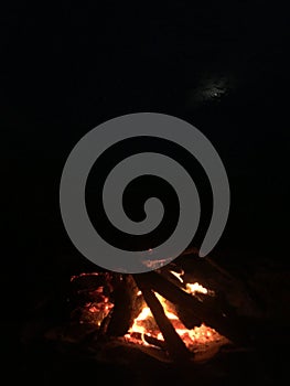 Fire on Beach during Full Moon Rising on Kauai Island, Hawaii.