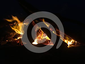 Fire on Beach during Full Moon Rising on Kauai Island, Hawaii.