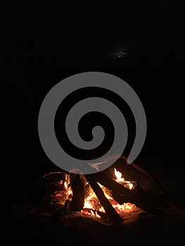 Fire on Beach during Full Moon Rising on Kauai Island, Hawaii.