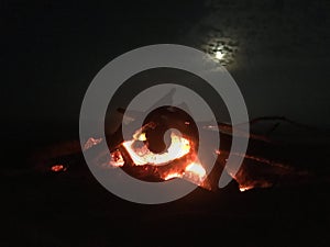 Fire on Beach during Full Moon Rising on Kauai Island, Hawaii.