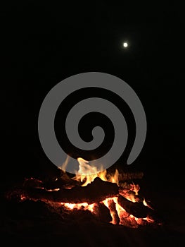 Fire on Beach during Full Moon Rising on Kauai Island, Hawaii.