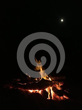 Fire on Beach during Full Moon Rising on Kauai Island, Hawaii.