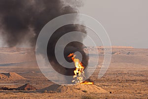 Fire and black smoke of burning oil during a fire power demonstartion of the Israeli Defence Forces in the Negev Desert