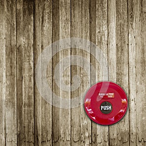 Fire break glass alarm switch on wooden wall background