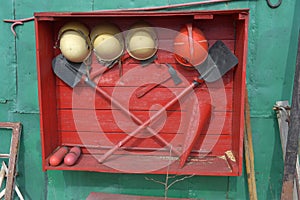 Fire brigade shield with shovels and helmets