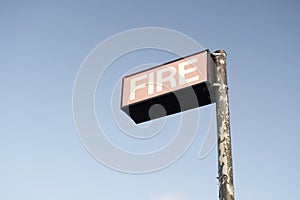 Fire brigade station sign in empty blank blue sky