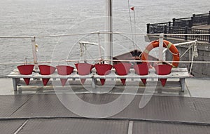 Fire buckets and lifebuoy on the deck of the ship
