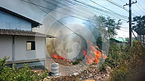 Fire burn abandoned house and wires. Destruction by Surface Fire while dry season. Footage 4k