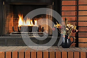 Fire burning with artificial log in fireplace