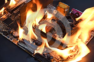 Fire Burning ,blazing computer motherboard, cpu,gpu and video card, processor on circuit board with electronic