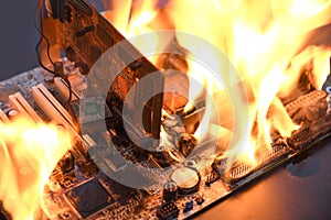 Fire Burning ,blazing computer motherboard, cpu,gpu and video card, processor on circuit board with electronic