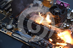 Fire Burning ,blazing computer motherboard, cpu,gpu and video card, processor on circuit board with electronic
