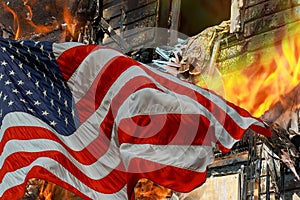 Fire burning in the engulfs small house and the American Flag
