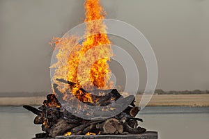 Fire in Burning Ghat Ganges riverbank in Varanasi, India