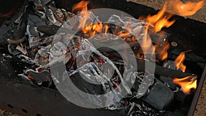 The fire is burning in the grill. Preparation of coals for roasting shish kebab
