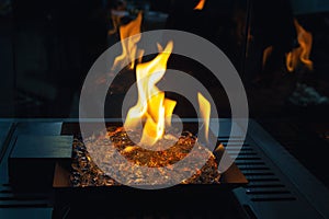 Fire burns in a fireplace with a close up