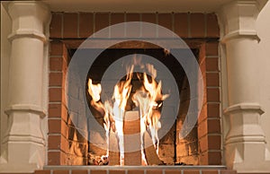 A fire burns in a fireplace, Fire to keep warm. Close up shot of burning firewood in the fireplace