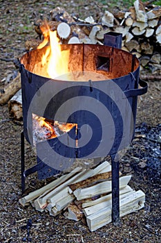 Fire burns in a large hiking stove