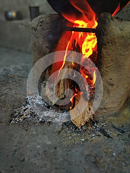 Fire burns in the mud stove