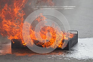 Fire burns in a training container